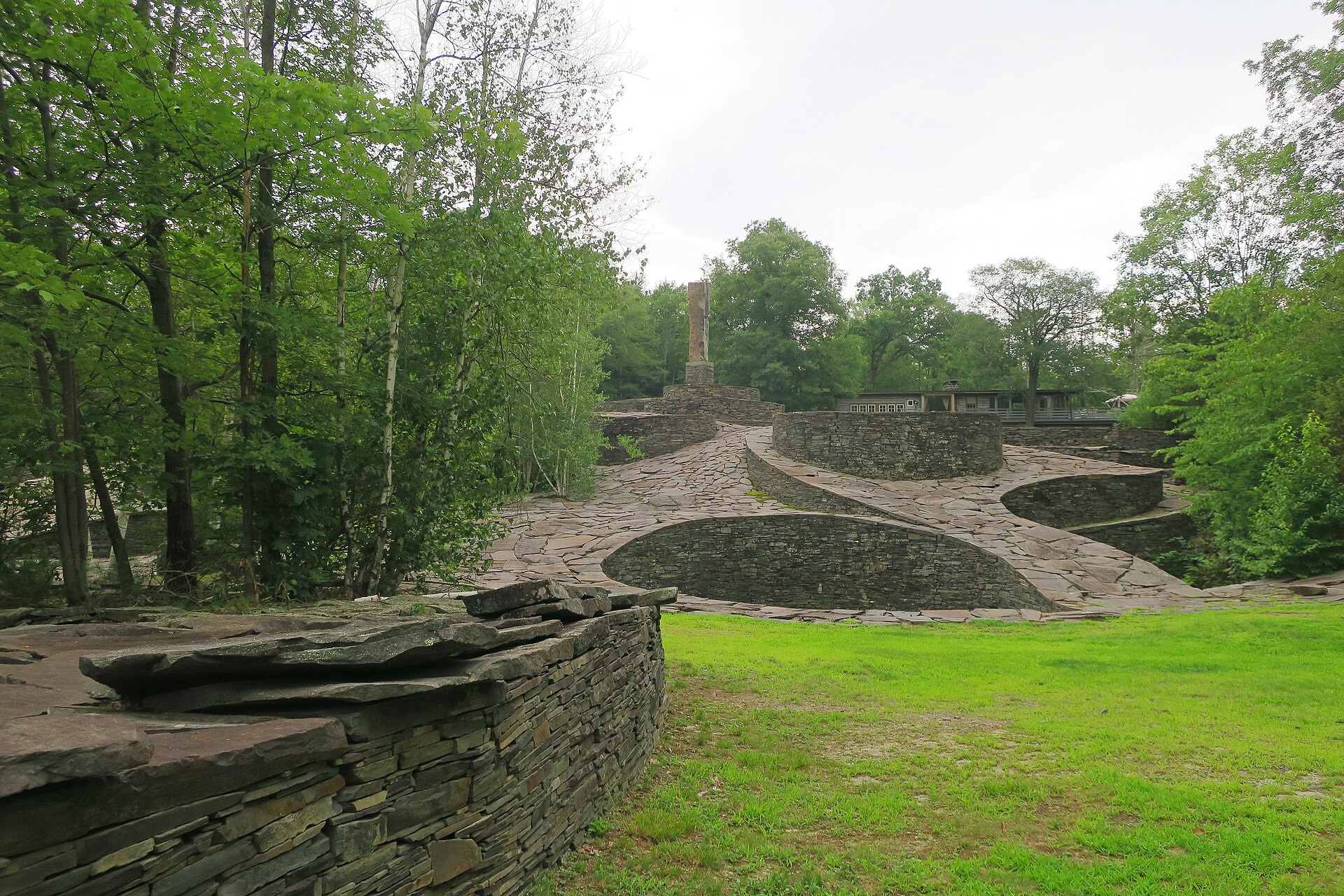 Broad view of Opus 40's curving terraces and central monolith